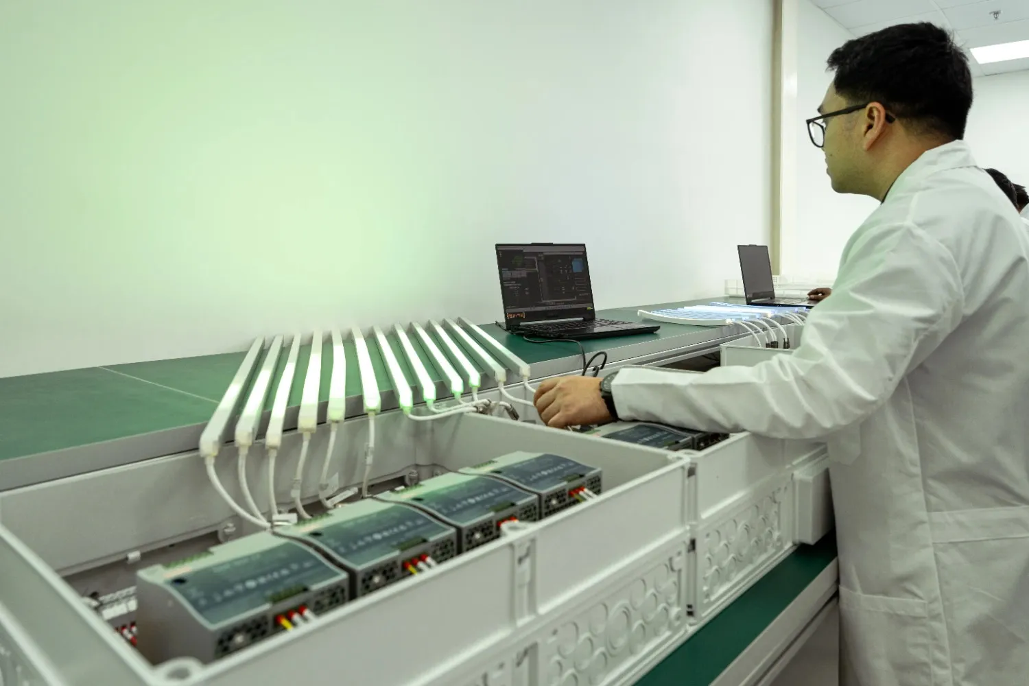 Engineer configuring and testing LED lighting control systems during commissioning at LEDFlex